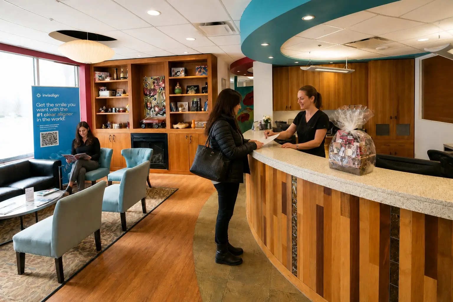 Receptionist helping a patient at the Glenora Dental Family Dentistry front desk