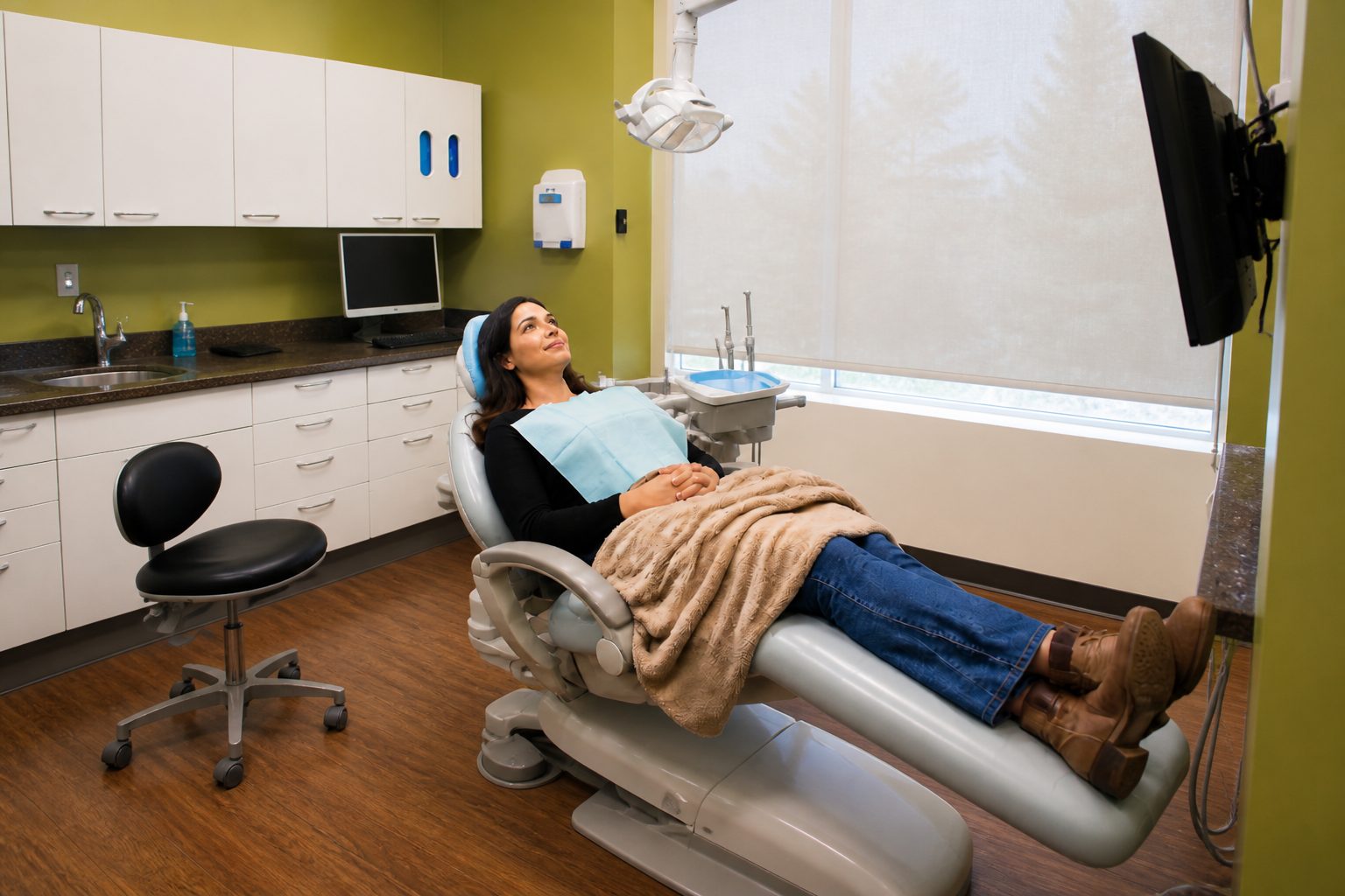 Relaxed adult patient watching TV during a comfortable dental visit