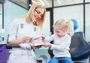 female dentist and young patient in dental office