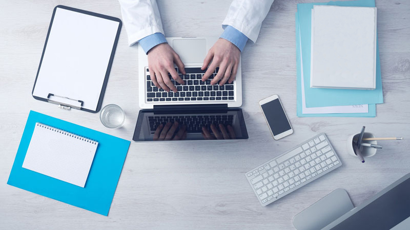 dentist typing at a computer