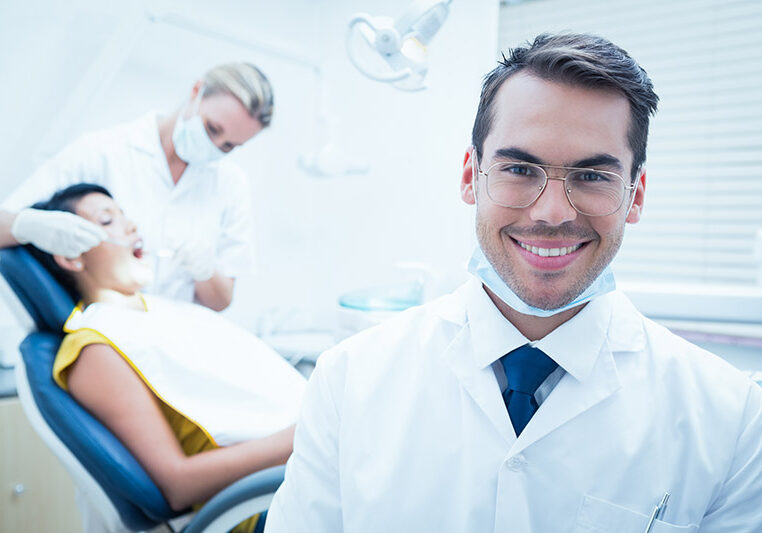 smiling male dentist is Edmonton, AB